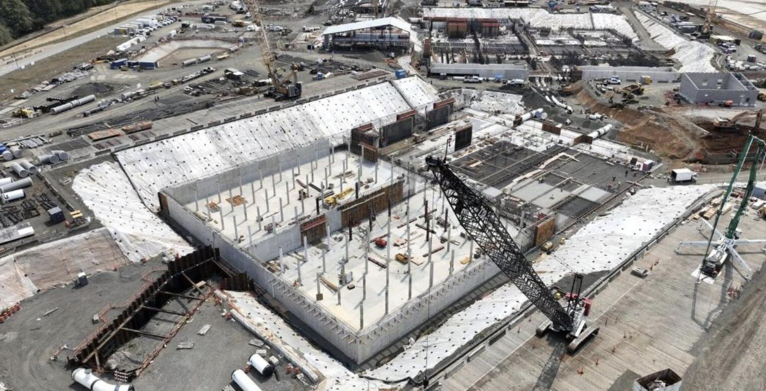 Aerial view of the Bull Run water filtration facility under construction in Oregon, with a tower crane and concrete structure